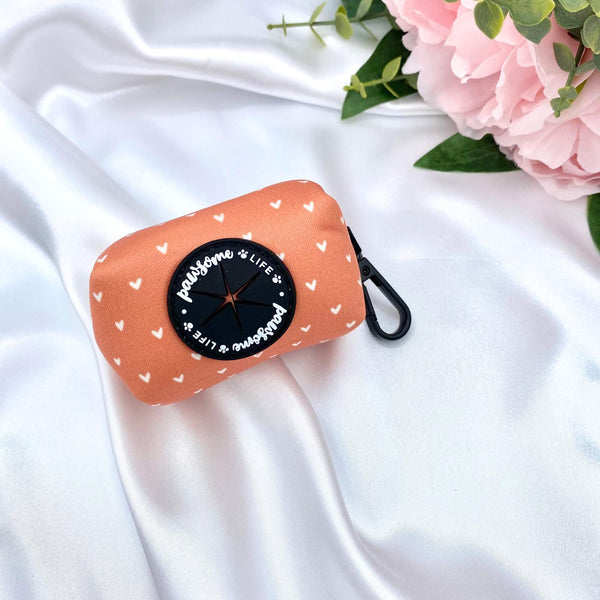 Cute dog poop bag holder featuring a boho cinnamon-themed orange pattern with hearts, perfect for stylish pet owners