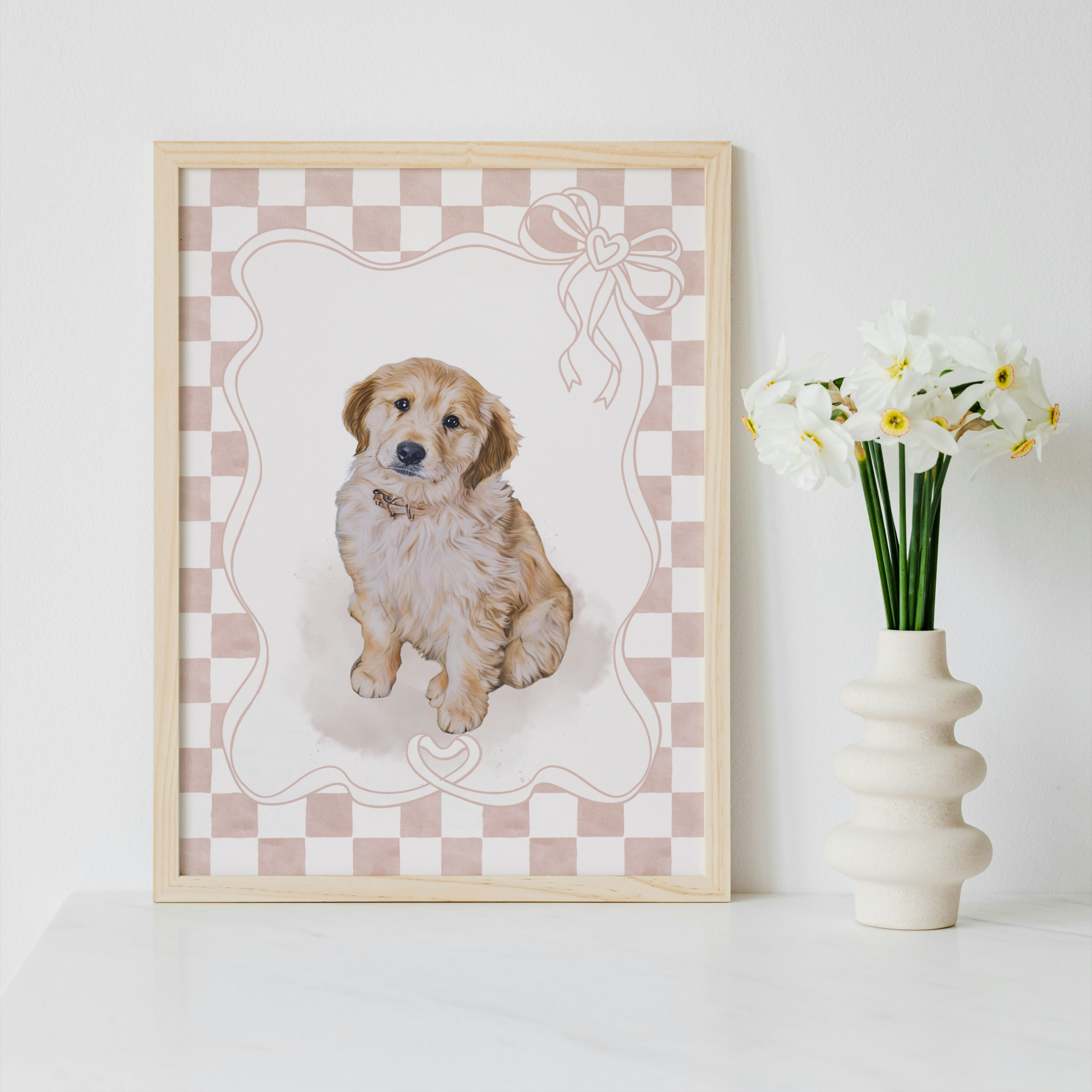 Framed print of a puppy on a checkered background with a vase of flowers next to it.
