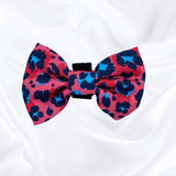 Cute dog bow with a trendy pink leopard design, adding a touch of flair to your pet's look