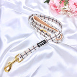 Stylish plaid dog leash featuring a secure golden clasp for easy attachment