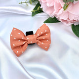 Cute dog bow tie with a boho cinnamon-themed orange pattern with hearts, easy to attach with its velcro fastening
