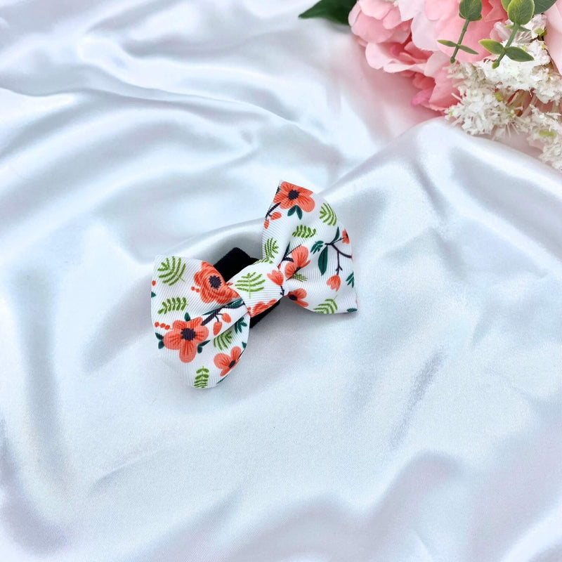 Cute dog bow with a charming floral design, adding a touch of elegance to your pet's look