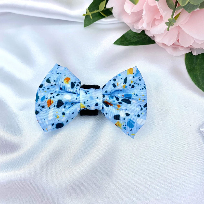Cute dog bow with a trendy blue terrazzo design, adding a touch of flair to your pet's look