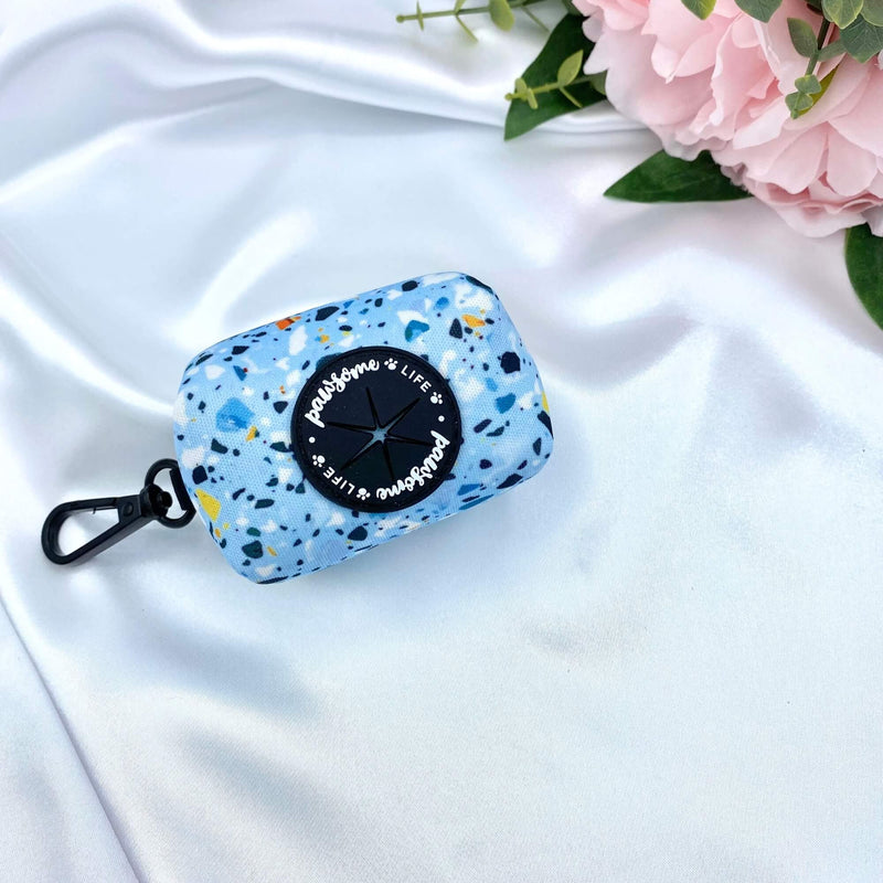 Cute dog poop bag holder featuring a trendy blue terrazzo design, a fashionable accessory for pet waste disposal