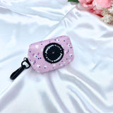 Cute dog poop bag holder featuring a pink, lilac, and purple design, a stylish accessory for pet waste disposal
