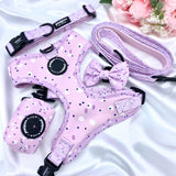 Fashionable dog bow adorned with a playful pink, lilac, and purple design, a stylish accessory for your furry friend
