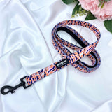 Stylish dog leash adorned with a trendy orange leopard print, perfect for fashionable walks