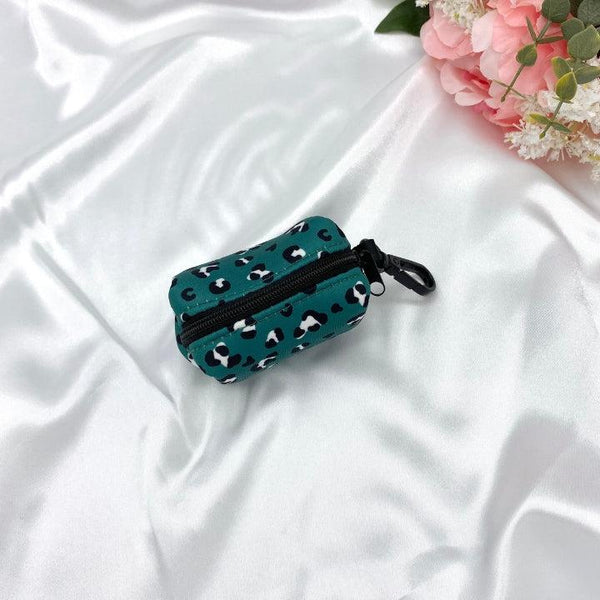Designer dog waste bag holder with a unique green leopard pattern, blending practicality with style