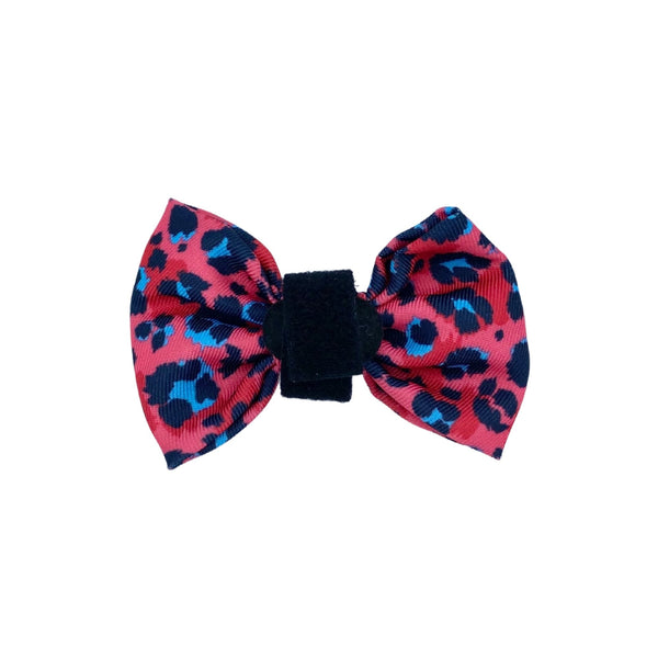 Stylish dog bow featuring a vibrant pink leopard pattern, perfect for adding a pop of style