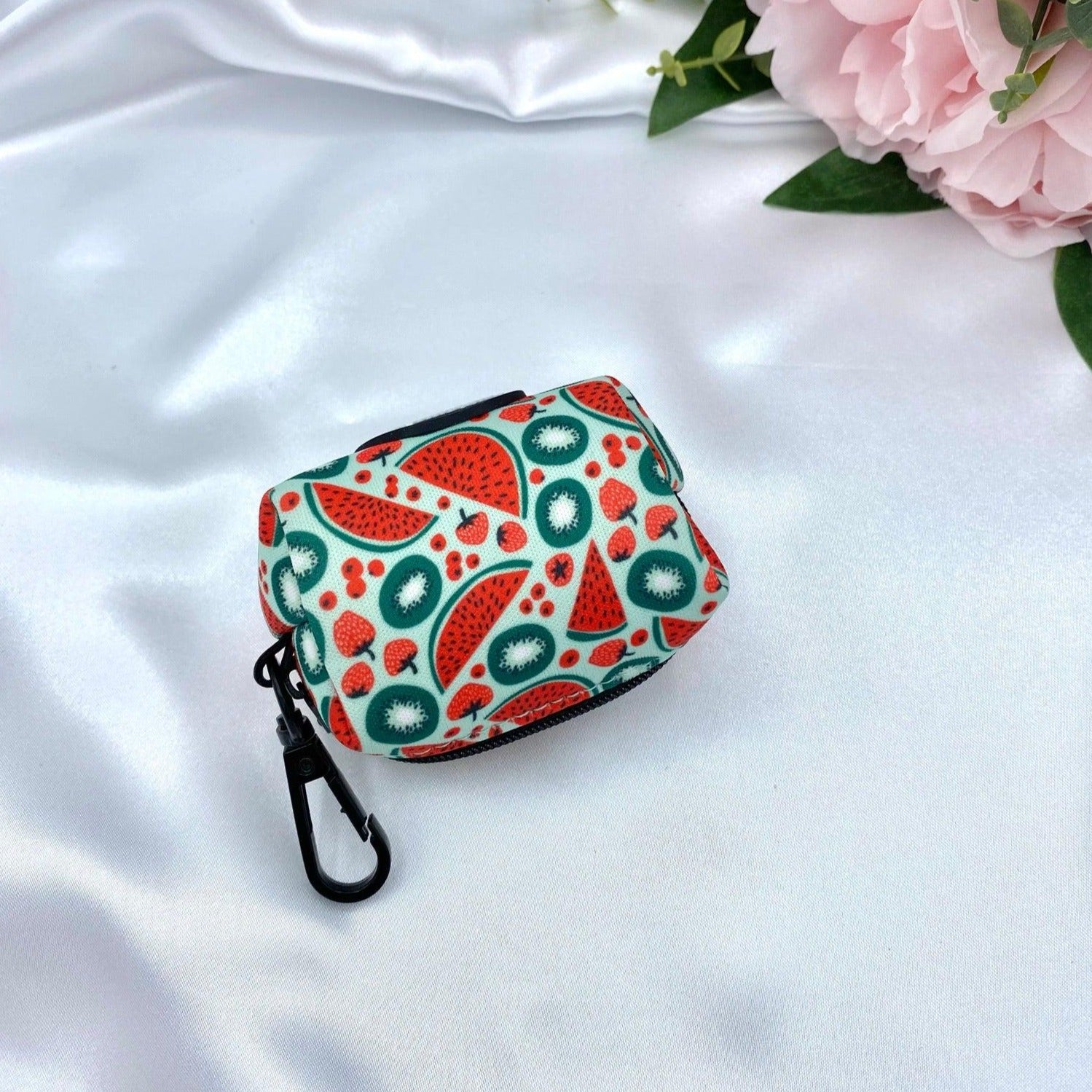 Designer watermelon-patterned poop bag dispenser, combining practicality with unique design