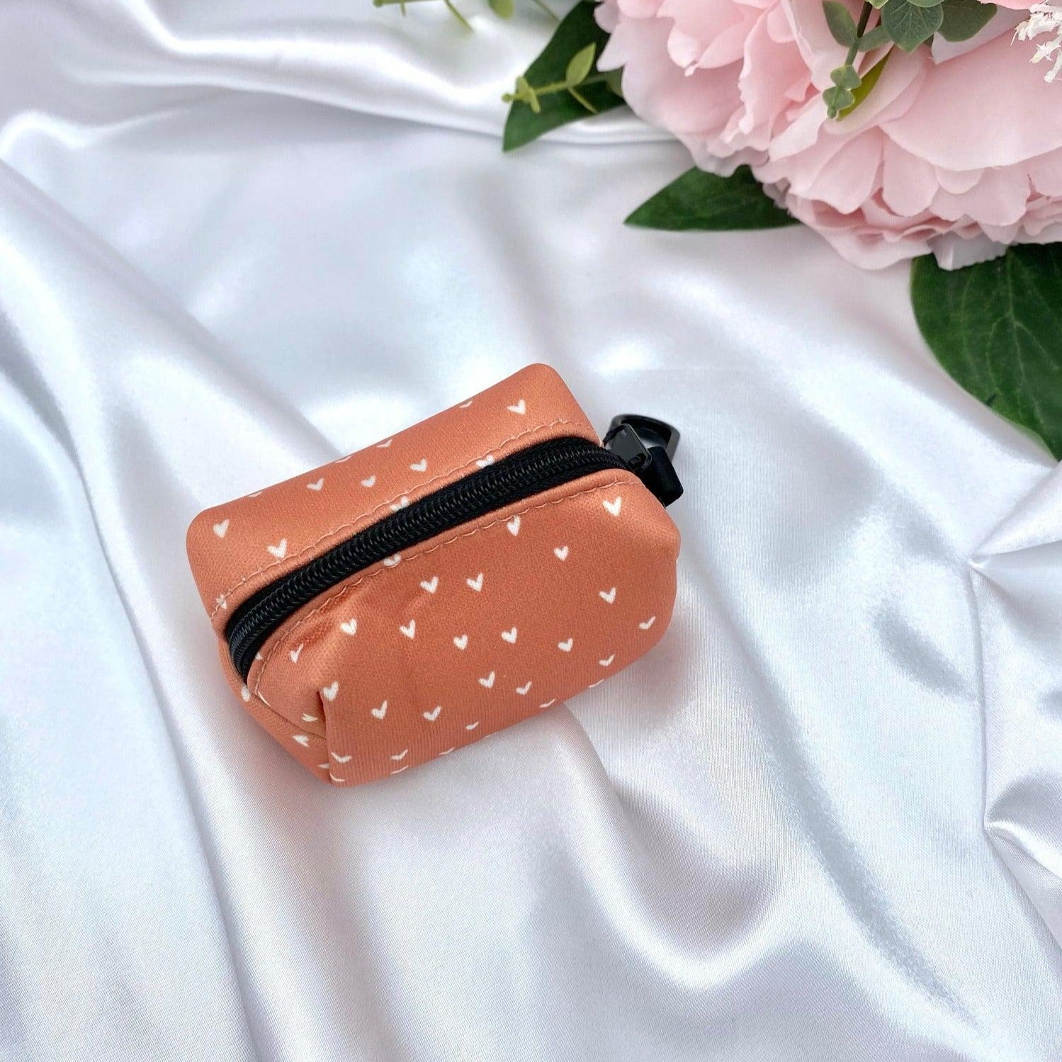 Designer dog waste bag holder with a unique boho cinnamon design and orange hearts, blending practicality with style