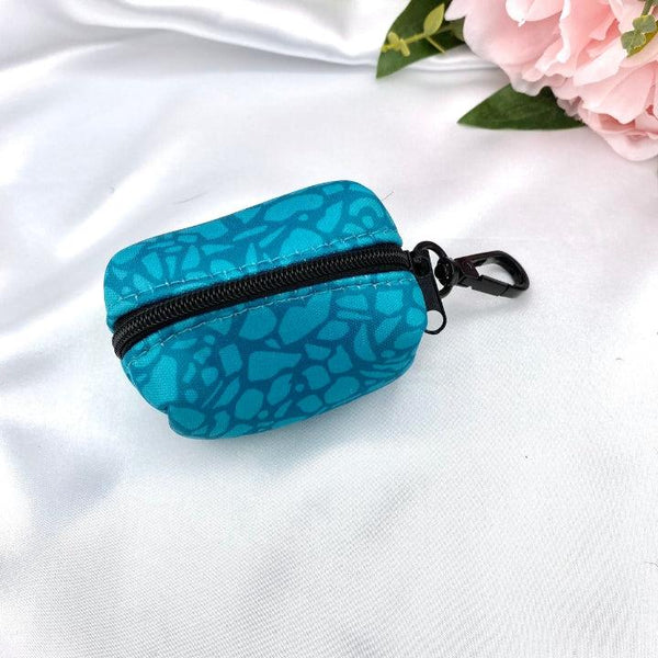 Designer dog waste bag holder with a unique dark teal abstract pattern, blending practicality with style