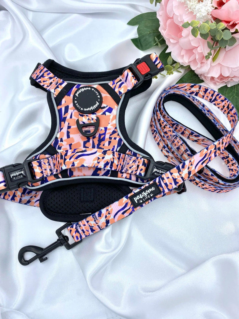 Adjustable dog harness adorned with a chic orange leopard pattern, offering both style and comfort